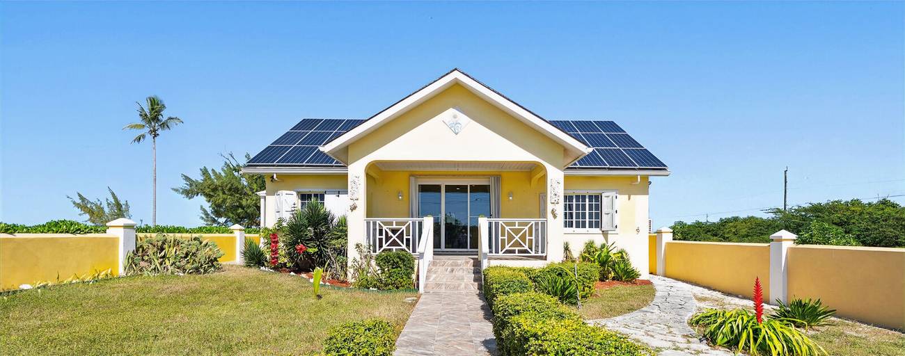Villa front under a clear blue sky