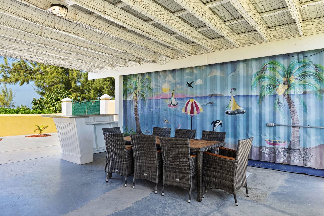 Shaded outdoor dining area with wicker chairs