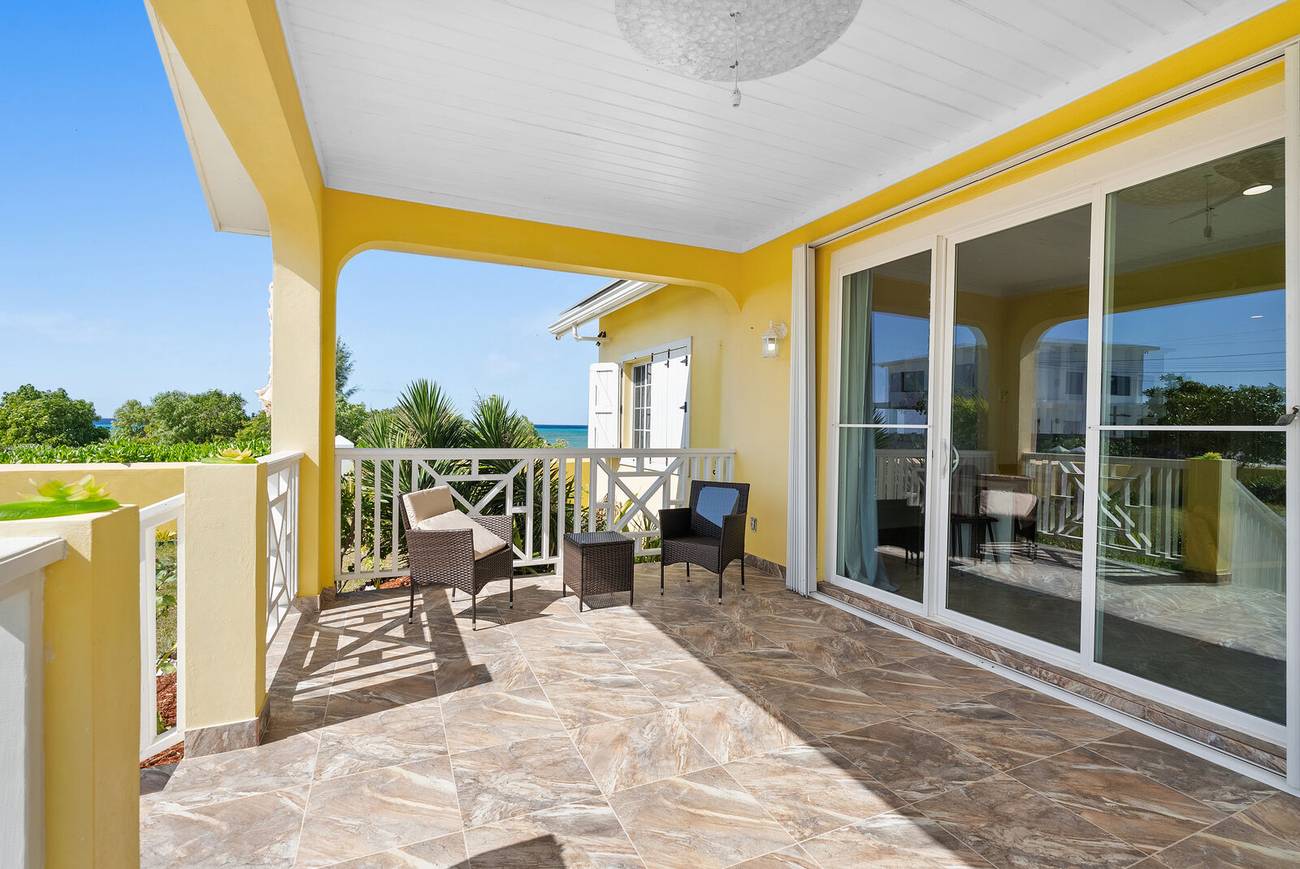 Covered veranda with yellow columns and sea view